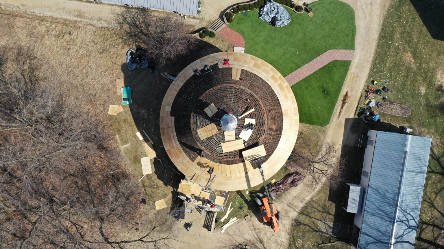 Top-down drone view of radial plywood decking pattern on the round barn dome