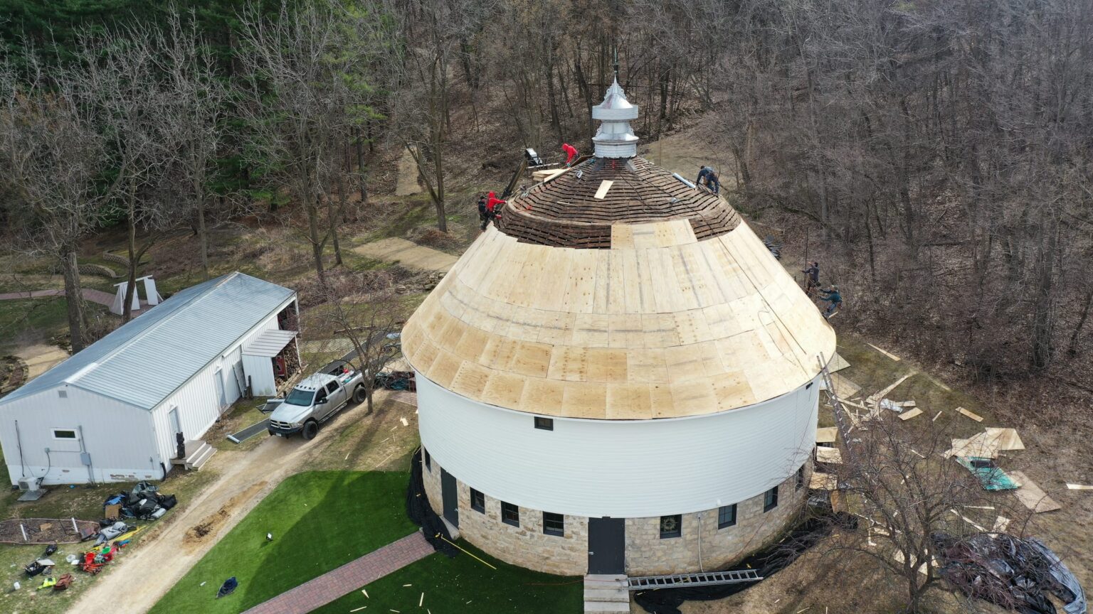 Round barn roof restoration in progress, aerial view