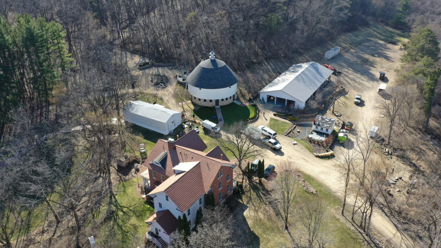 Round barn roof installation, aerial establishing view